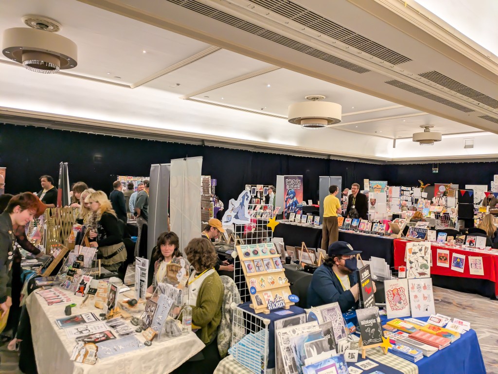 A busy room in a comics convention
